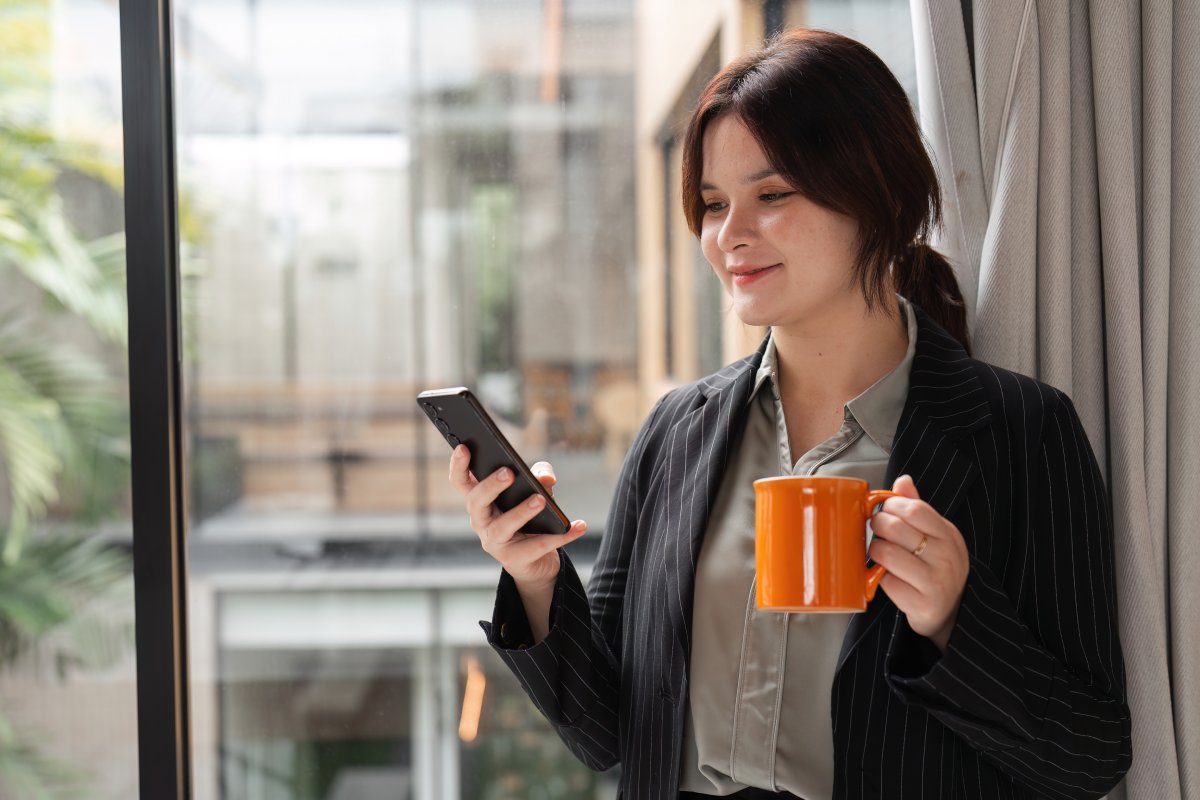 Executive habitually checking training performance dashboard on mobile device