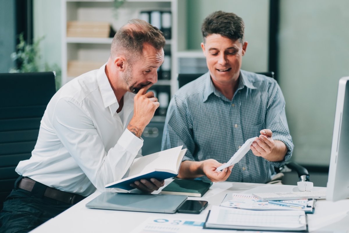 Training consultant presenting first 30-day impact report to impressed client